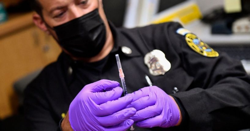 A Culver City Fire Department paramedic prepares a syringe with a dose of the Johnson & Johnson COVID-19 vaccine on Aug. 5 in Culver City, California.