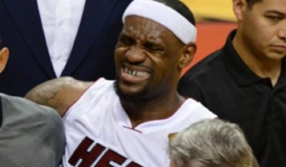NBA star LeBron James is carried off the court with leg cramps during Game 4 of the NBA Finals in 2012.