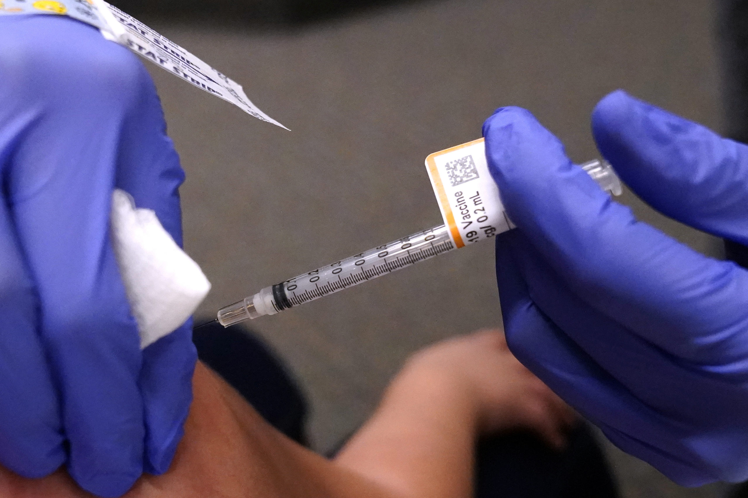 An 8-year-old child receives a second dose of the Pfizer COVID-19 vaccine at Northwest Community Church in Chicago on Saturday.