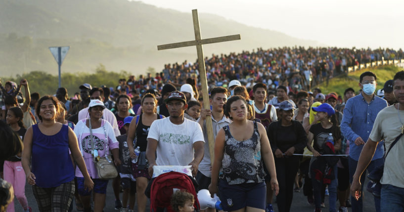 Migrants leave Huixtla, Chiapas state, Mexico, Oct. 27 as they continue their trek north toward Mexico's northern states and the U.S. border. The Biden administration struck agreement with Mexico to reinstate a Trump-era border policy next week that forces asylum-seekers to wait in Mexico for hearings in U.S. immigration court, U.S. officials said Thursday.