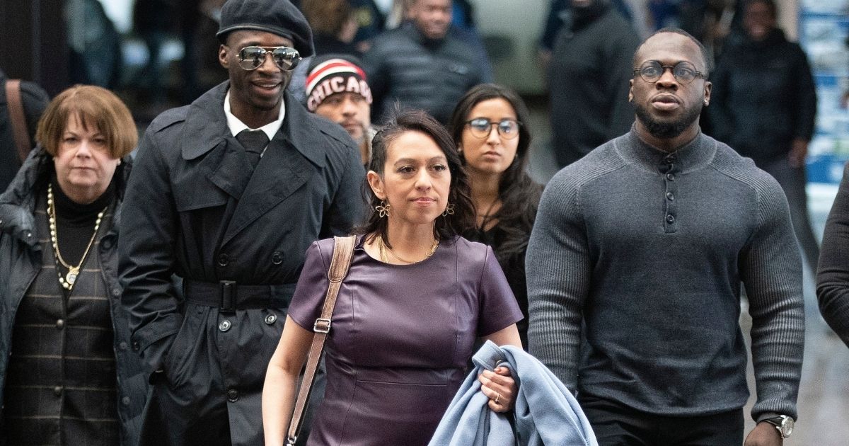Attorney Gloria Schmidt Rodriguez, center, and Abimbola and Ola Osundairo, right, arrive at the Leighton Criminal Courthouse on Feb. 24, 2020, in Chicago.