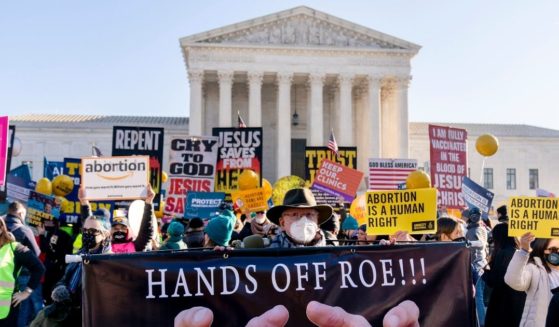 Protesters holding signs for and against abortion demonstrate in front of the U.S. Supreme Court Dec. 1. A recent poll that asked for abortion stories drew a surprisingly strong response from pro-lifers.