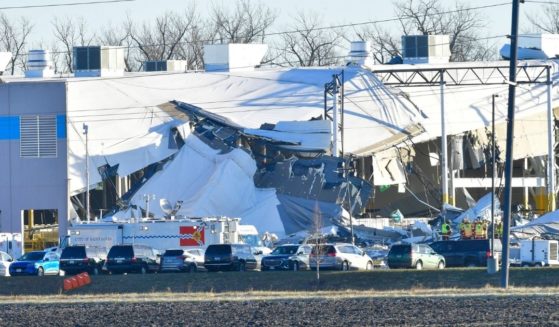 An Amazon Fulfillment Center in Edwardsville, Illinois is seen on December 12, the day after a tornado slammed into the building, killing six employees. One driver has said she was told to stay on her route, even though tornado sirens were going off nearby.