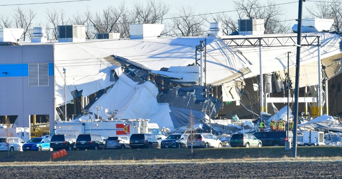 An Amazon Fulfillment Center in Edwardsville, Illinois is seen on December 12, the day after a tornado slammed into the building, killing six employees. One driver has said she was told to stay on her route, even though tornado sirens were going off nearby.
