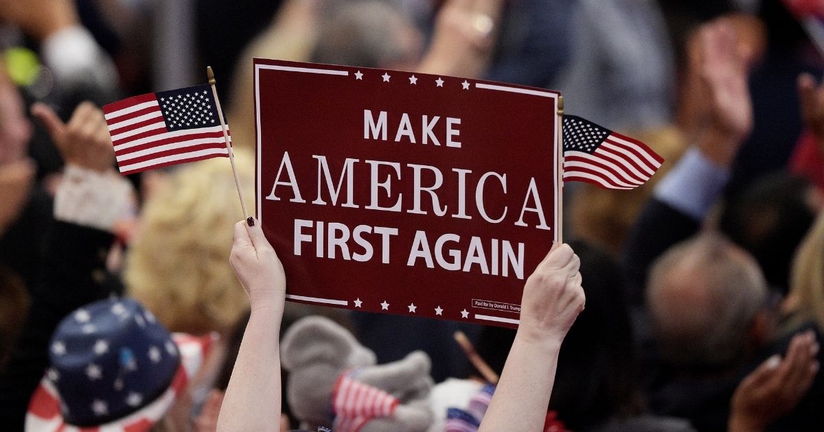 A delegate holds up a "Make America First Again" sign during the opening of the third day of the Republican National Convention at the Quicken Loans Arena in Cleveland on July 20, 2016.