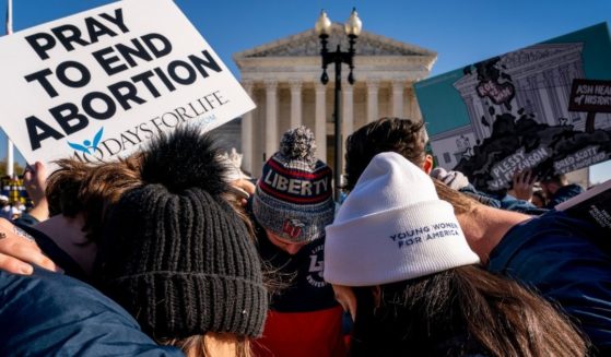 A group of anti-abortion protesters gather outside the United States Supreme Court in Washington, D.C., on Wednesday to pray.