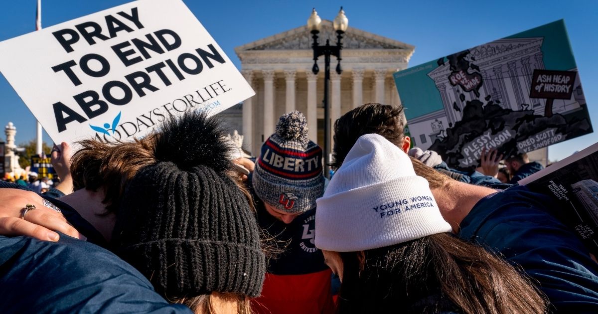 A group of anti-abortion protesters gather outside the United States Supreme Court in Washington, D.C., on Wednesday to pray.