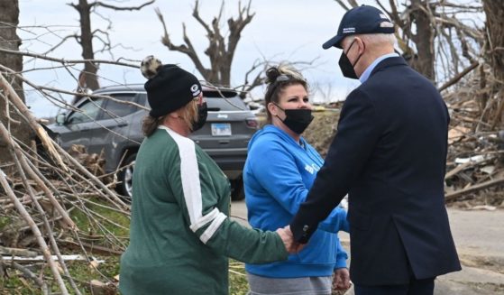 President Joe Biden talks with residents as he tours storm damage in Dawson Springs, Kentucky, on Wednesday.