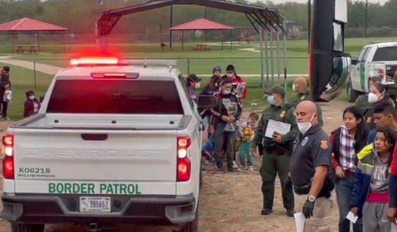 On Dec. 9, hundreds of migrants crossed the U.S. Mexico border near La Joya, Texas, with border patrol buses waiting to collect them and agents watching without being able to stop those crossing.