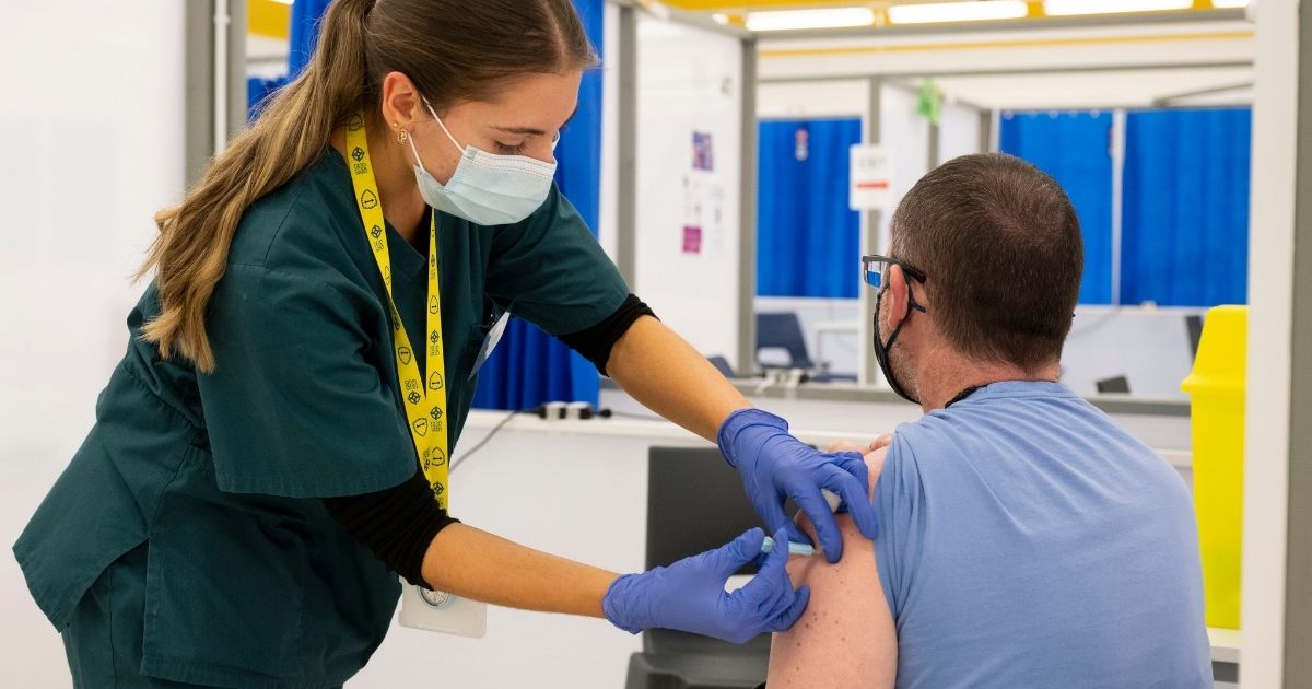 A man is vaccinated at the Cardiff Bay mass vaccination center on Wednesday in Cardiff, Wales.