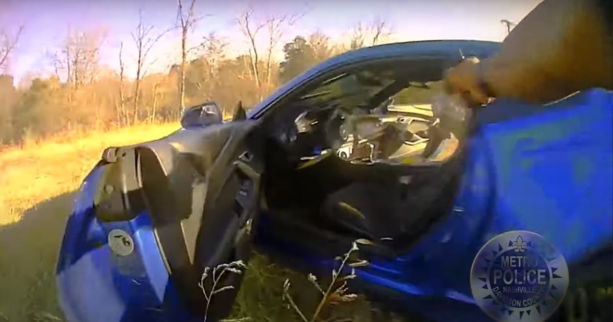 Officer Byron Boelter of the Metro Nashville Police Department fires his gun after a man inside a vehicle involved in a car crash allegedly attempted to reach for one himself.