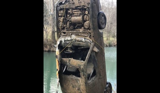 A rusted car belonging to one of two missing teenagers is pulled out of the Calfkiller River in Tennessee.