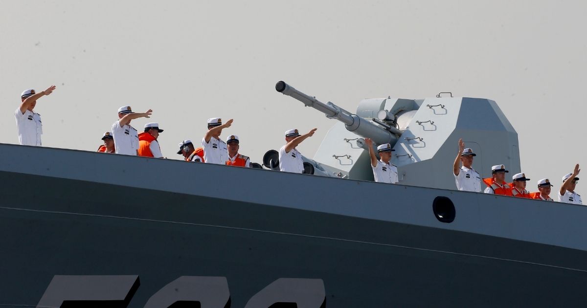 A Chinese Navy crew waves from the deck of a 054A guided missile frigate as it docks in Manila, Philippines, on Jan. 17, 2019.