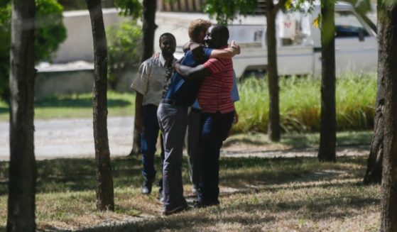 People hug at the Christian Aid Ministries headquarters in Titanyen, north of Port-au-Prince, Haiti, on Thursday.