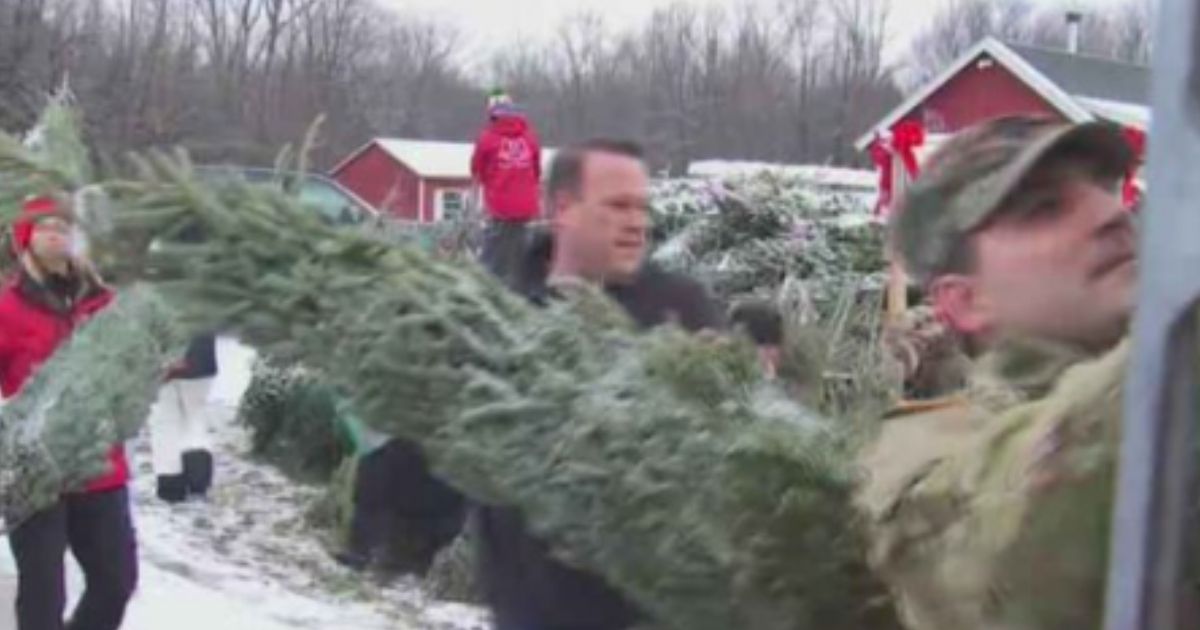 Christmas Spirit Foundation volunteers in Ballston Spa, New York, help load a Fed Ex truck with Christmas trees to send to military personnel, sending some Christmas cheer.