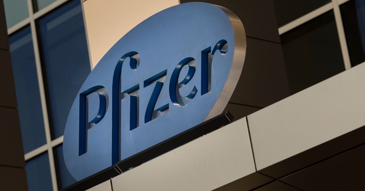 A sign for Pfizer pharmaceutical company is seen on a building in Cambridge, Massachusetts, in this file photo from March 2017. The Food and Drug Administration has given Emergency Use Authorization to a Pfizer drug to treat early symptoms of COVID-19.