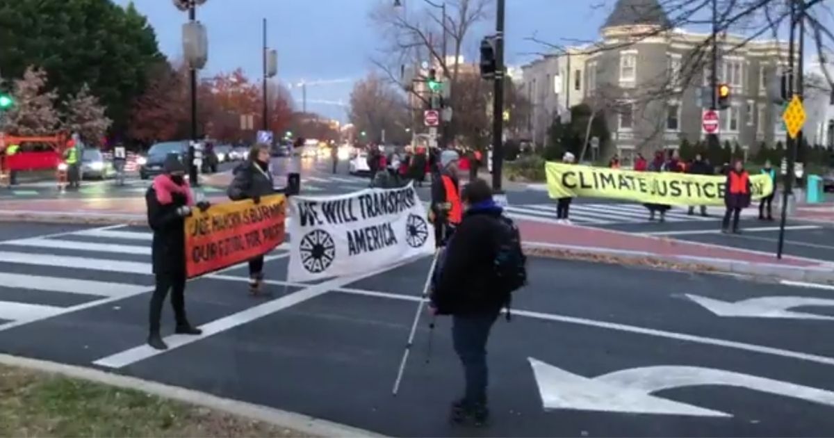 Climate protesters begin blocking intersections in Washington, D.C., to block rush hour traffic on Tuesday morning.