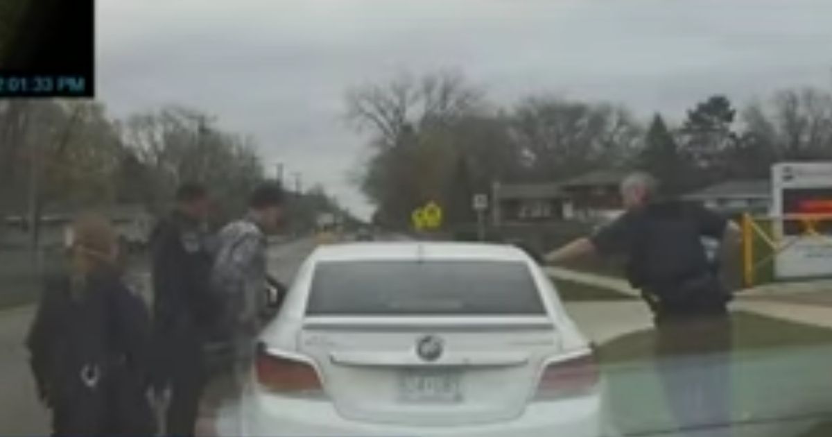 Brooklyn Center police officers begin putting handcuffs on Daunte Wright after pulling him over in Minnesota.