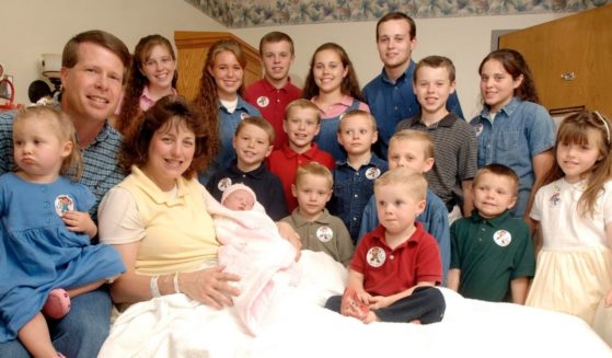 Michelle Duggar, left center, and husband Jim Bob, second from left, are seen surrounded by their 17 children after the birth of their 17th child on Aug. 2, 2007; the family was made famous on the popular TLC show "19 Kids and Counting."