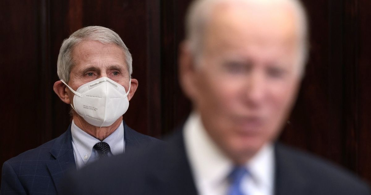 Anthony Fauci, director of the National Institute of Allergy and Infectious Diseases, listens as President Joe Biden, right, delivers remarks on the omicron COVID-19 variant following a meeting of the COVID-19 response team at the White House on Nov. 29 in Washington, D.C.