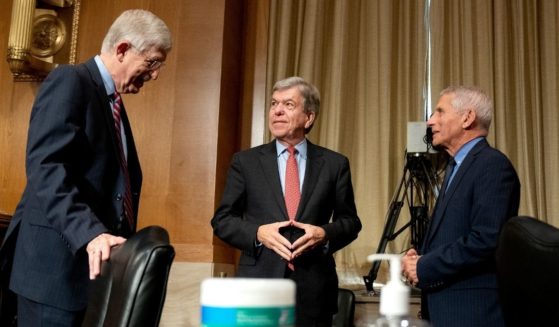Dr. Francis Collins, director of the U.S. National Institutes of Health, left, stands opposite Dr. Anthony Fauci, director of the National Institute of Allergy and Infectious Diseases, right, following a Senate Appropriations Subcommittee hearing on May 26 on Capitol Hill in Washington, D.C.