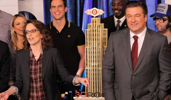 Tina Fey and Alec Baldwin are seen celebrating the 100th episode of '30 Rock' in March 2011 in New York City. A new book recounts an incident in which Baldwin allegedly threatened to assault a director of that show.