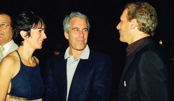 Ghislaine Maxwell, left, Jeffrey Epstein, center, and musician Michael Bolton pose for a portrait during a party at the Mar-a-Lago club in Palm Beach, Florida, on Feb. 12, 2000.