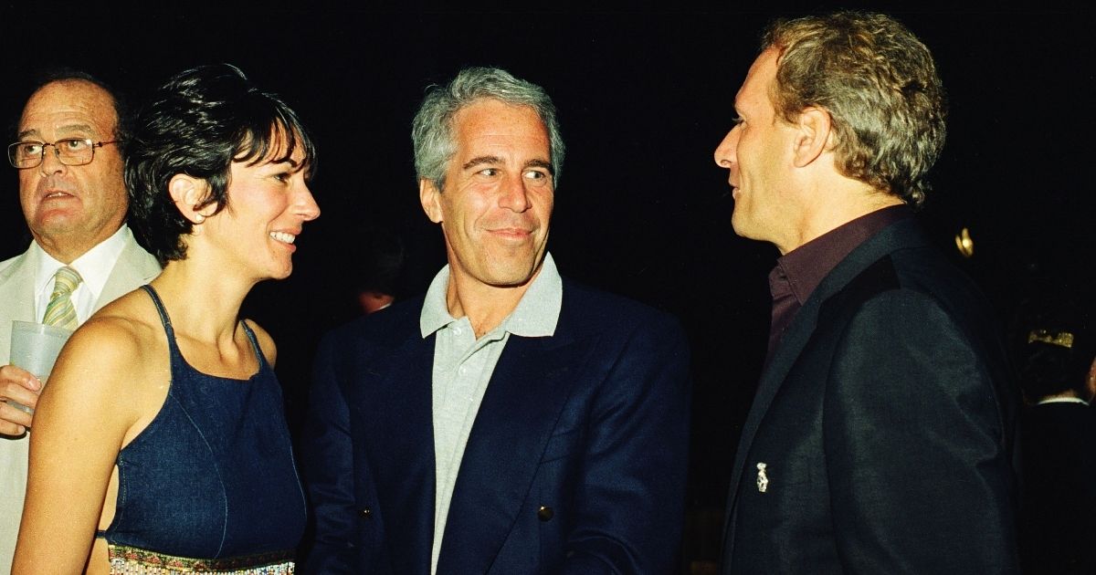 Ghislaine Maxwell, left, Jeffrey Epstein, center, and musician Michael Bolton pose for a portrait during a party at the Mar-a-Lago club in Palm Beach, Florida, on Feb. 12, 2000.
