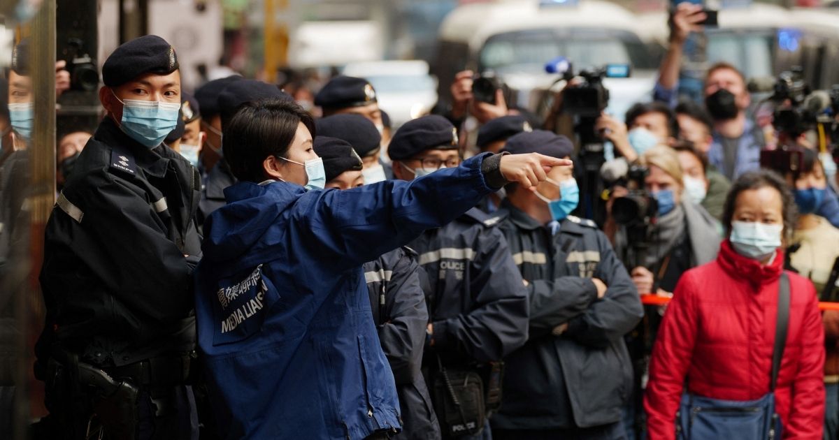 Police gather outside the offices of Stand News in Hong Kong on Wednesday during a raid of the media outlet.