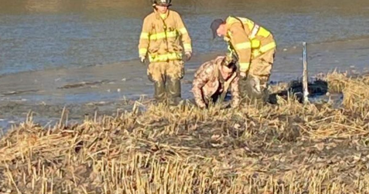 Firefighters assist a hunter who had become stuck in waist-deep mud while hunting in New Hampshire Sunday.