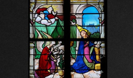 The Annunciation is depicted in a stained-glass window in Saint Catherines church in Honfleur, Calvados, France. An author who claims God is a black woman recently made a controversial claim about the Immaculate Conception.