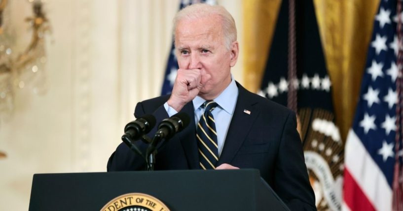 President Joe Biden coughs as he delivers remarks about the Build Back Better legislation's new rules around prescription drug prices in the East Room of the White House on Monday in Washington, D.C.