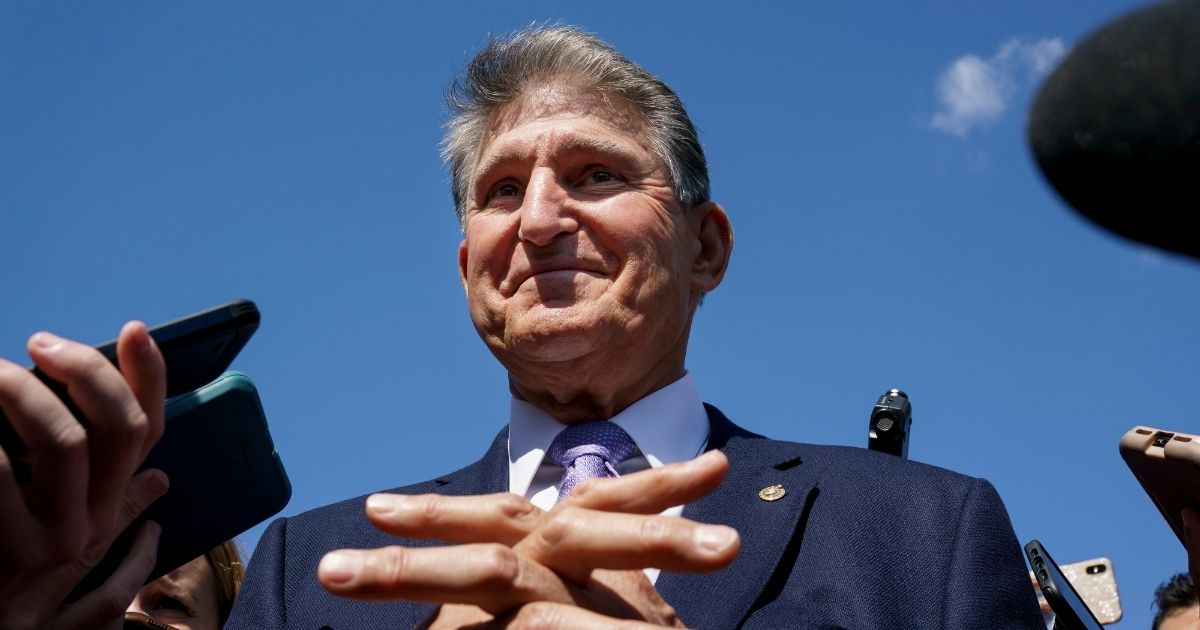Democratic Sen. Joe Manchin of West Virginia gives an update on his stance of the Build Back Better plan to reporters on Capitol Hill in Washington, D.C., on Sept. 30.