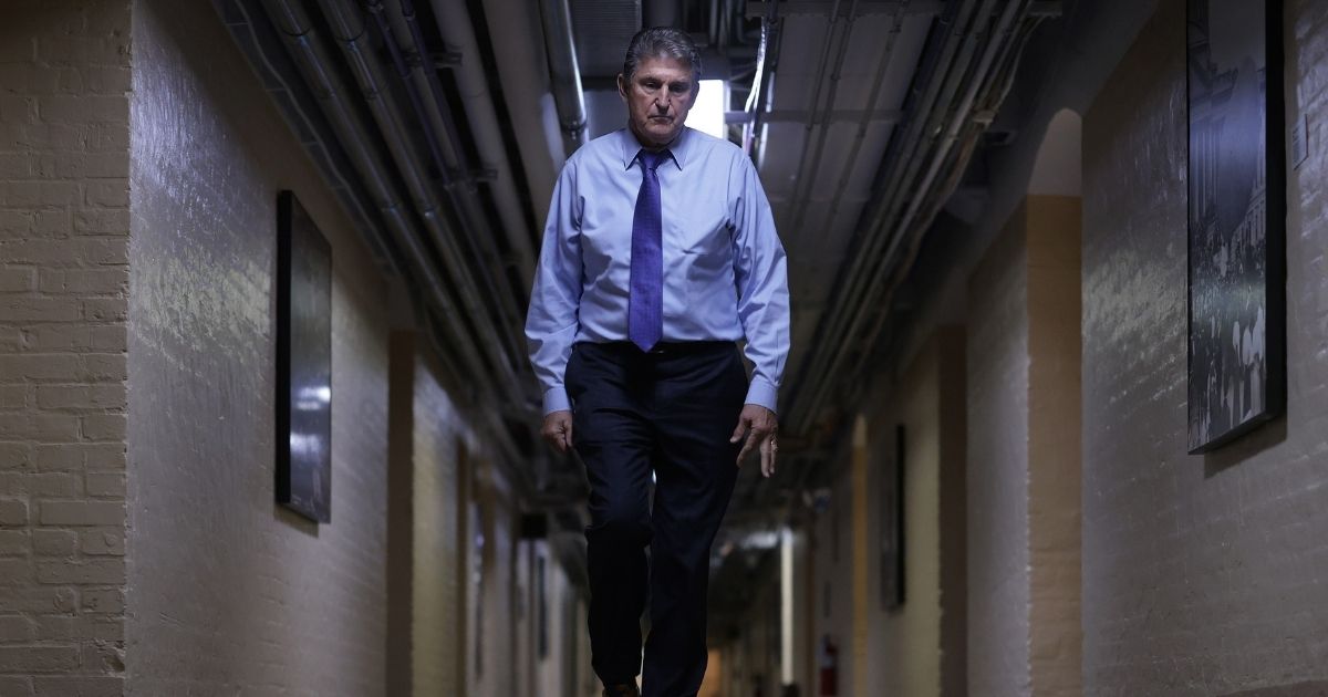 Sen. Joe Manchin walks through a hallway in the basement of the U.S. Capitol on Dec. 15 in Washington, D.C.