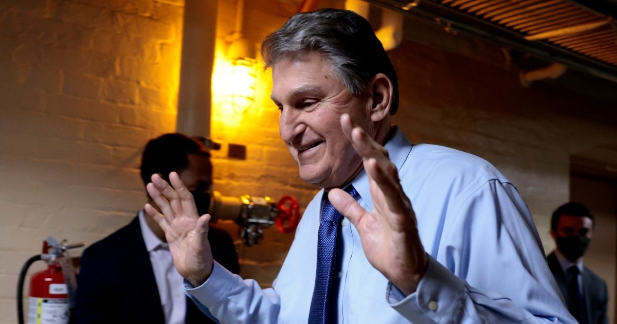 Sen. Joe Manchin of West Virginia walks out of a meeting with fellow Democratic senators for a break in the basement of the U.S. Capitol in Washington on Wednesday.