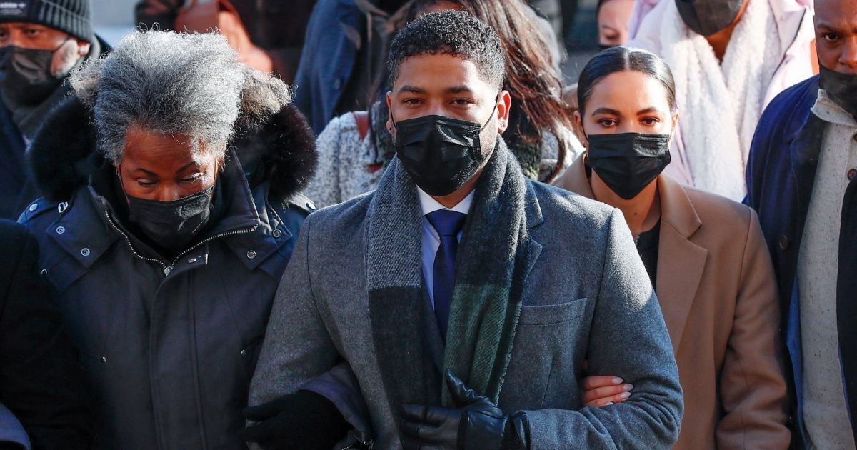 Jussie Smollett, center, arrives at the Leighton Criminal Court Building for closing arguments in his trial on felony disorderly conduct charges on Wednesday in Chicago.