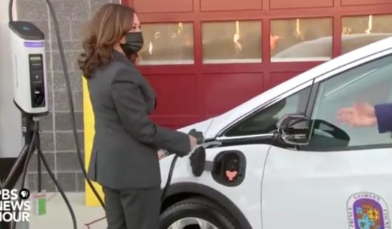 Vice President Kamala Harris attempts to charge an electric vehicle on Monday.