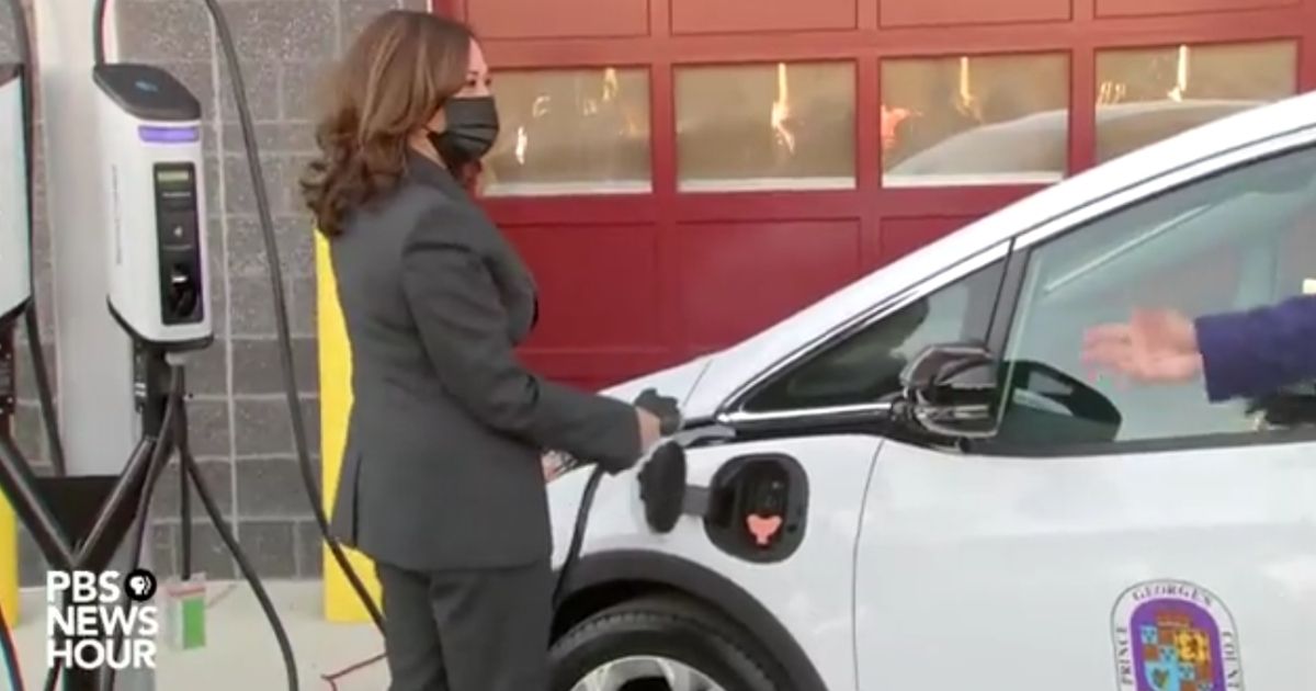 Vice President Kamala Harris attempts to charge an electric vehicle on Monday.