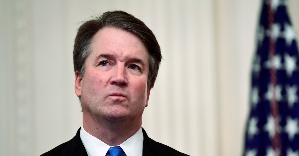 Supreme Court Justice Brett Kavanaugh stands in the East Room of the White House on Oct. 8, 2018 during a ceremonial swearing-in.