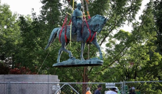 Workers remove a statue of Confederate Gen. Robert E. Lee from Market Street Park in Charlottesville, Virginia, on July 10.