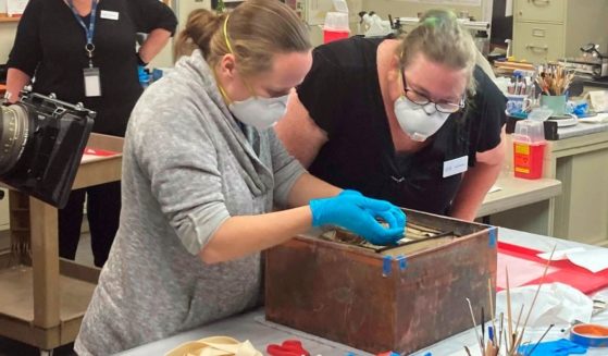Researchers remove items from a time capsule that had been buried beneath the pedestal that once held the statue of Confederate General Robert E. Lee in Richmond, Virginia.
