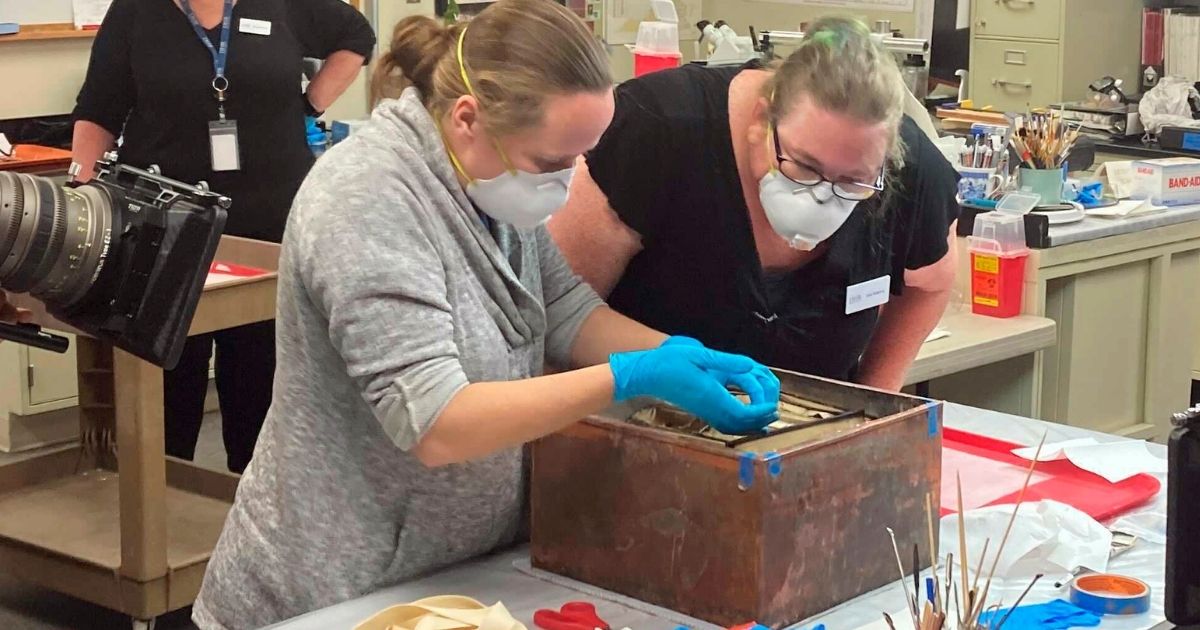 Researchers remove items from a time capsule that had been buried beneath the pedestal that once held the statue of Confederate General Robert E. Lee in Richmond, Virginia.