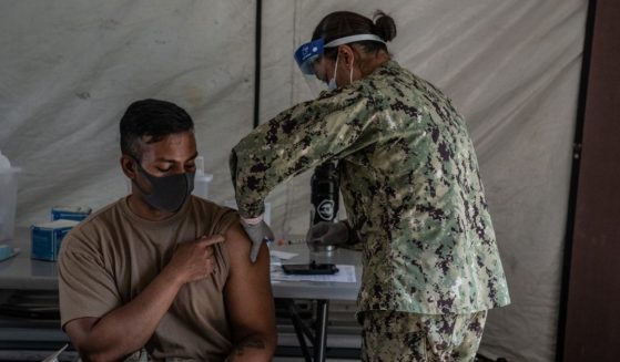 A member of the United States Marines receives a Moderna coronavirus vaccine at Camp Foster in Ginowan, Japan, in this file photo from April 2021. Several sources have anonymously said the US is apparently denying all vaccine waiver requests and is discharging Marines in a merciless fashion, doing as much harm to them as possible on their way out. One officer called it 'a political purge, taking out some of the best and brightest' in all branches of the US military.
