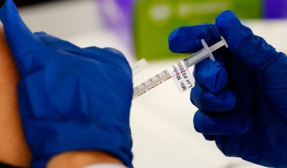 A health worker administers a dose of a Moderna COVID-19 vaccine during a vaccination clinic at the Norristown Public Health Center in Norristown, Pennsylvania, on Dec. 7.