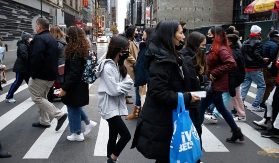 People cross the street in New York City's Midtown on Nov. 26.