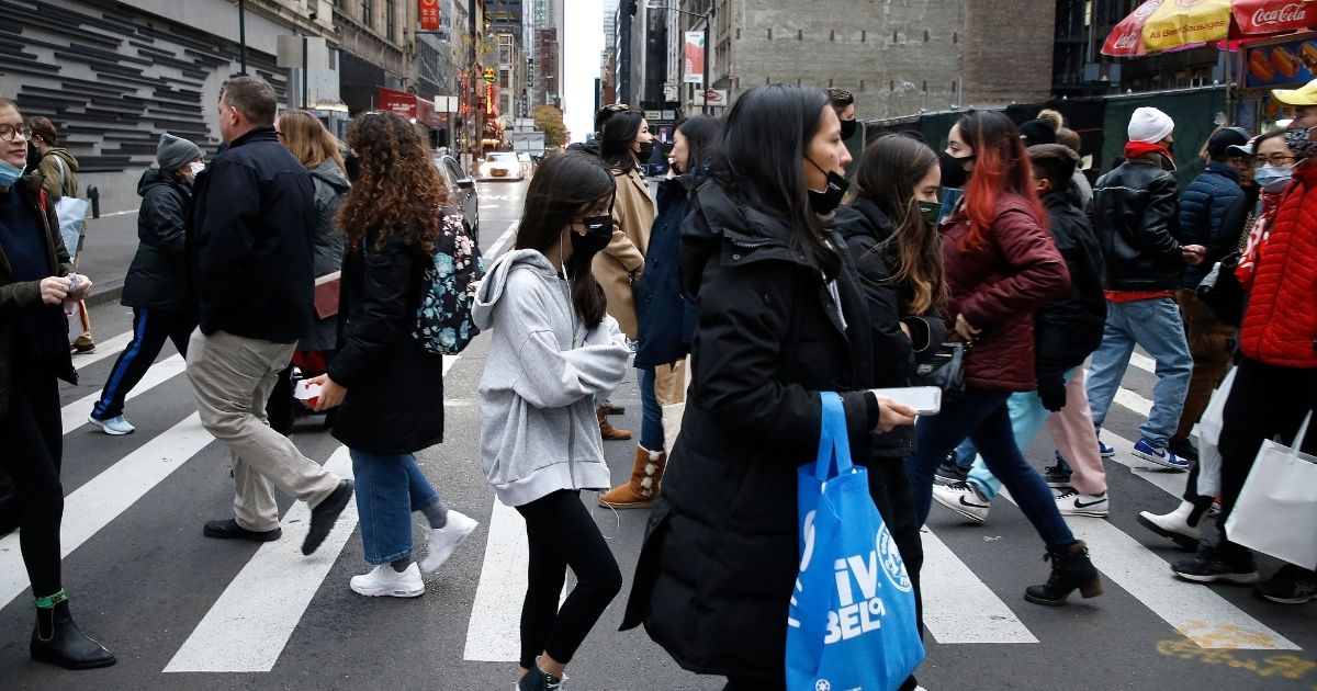 People cross the street in New York City's Midtown on Nov. 26.