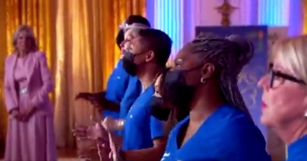 The Northwell Health Nurse Choir from Long Island, New York, performs in a televised Christmas special with First Lady Jill Biden in the background while more than 1,000 of their colleagues are facing unemployment due to President Joe Biden's vaccine mandate.