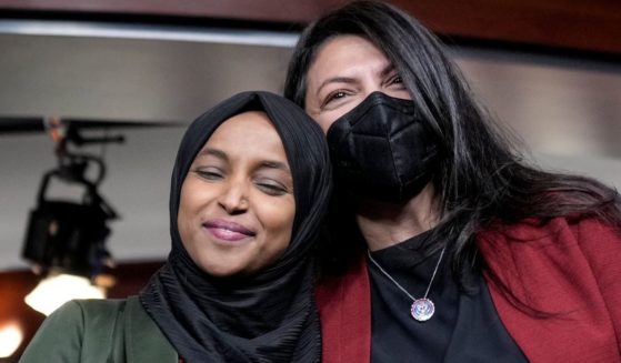 Democratic Rep. Ilhan Omar of Minnesota, left, gets a hug from Rep. Rashida Tlaib of Michigan during a news conference about "Islamophobia" on Capitol Hill in Washington on Nov. 30.