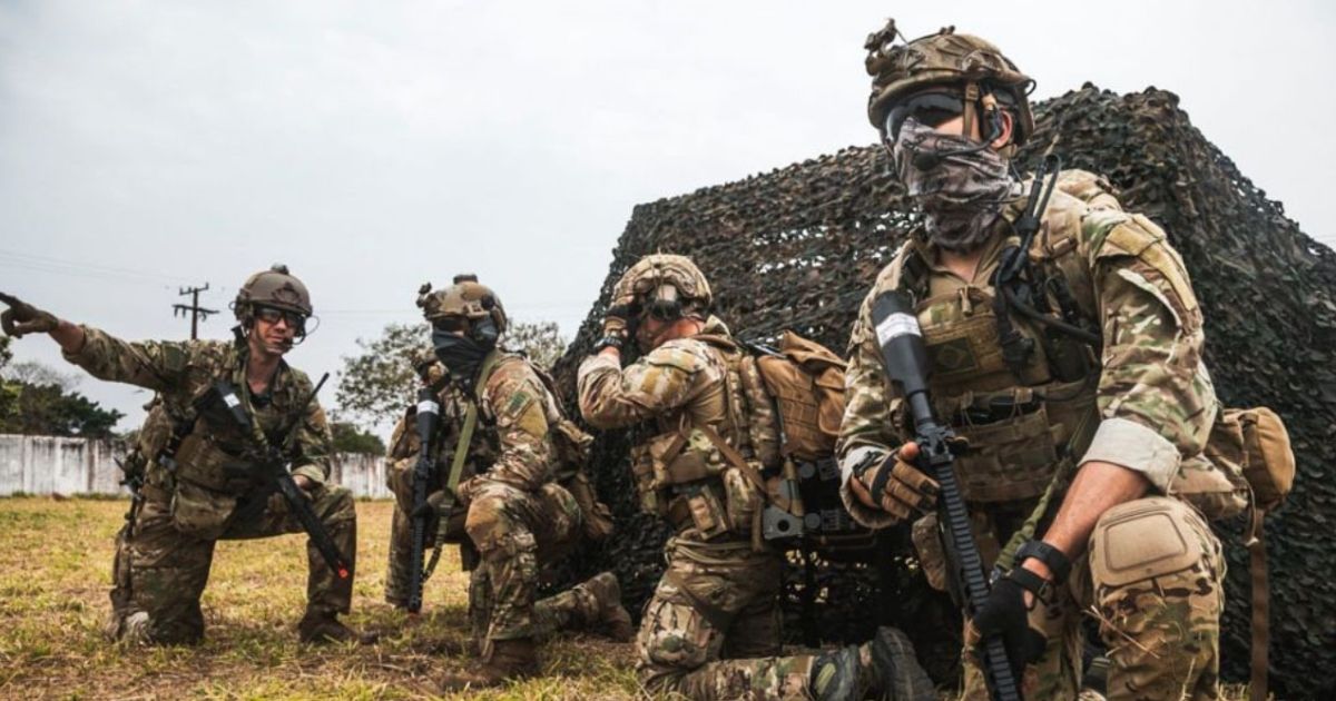 A Brazilian Air Force member, far left, passes on information to pararescuemen from the 106th Rescue Wing exiting an HH-60 Pave Hawk while participating in Exercise Tapio 2021.