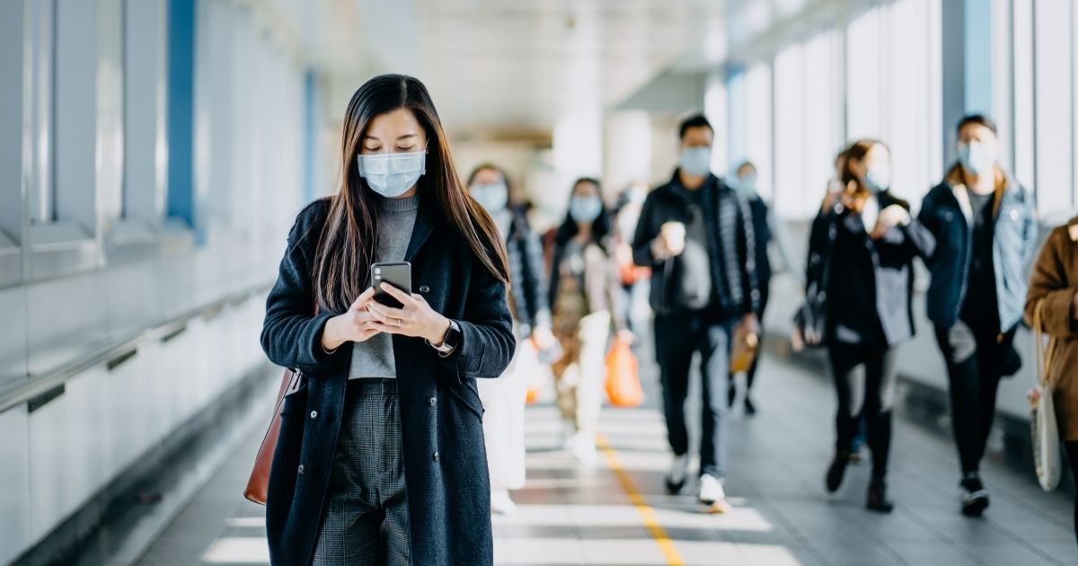 This stock image shows a group of people walking with masks on. A study in the possession of the United Kingdom Health Security Agency has reportedly found that the omicron variant will give individuals a more mild case of COVID-19 than delta.